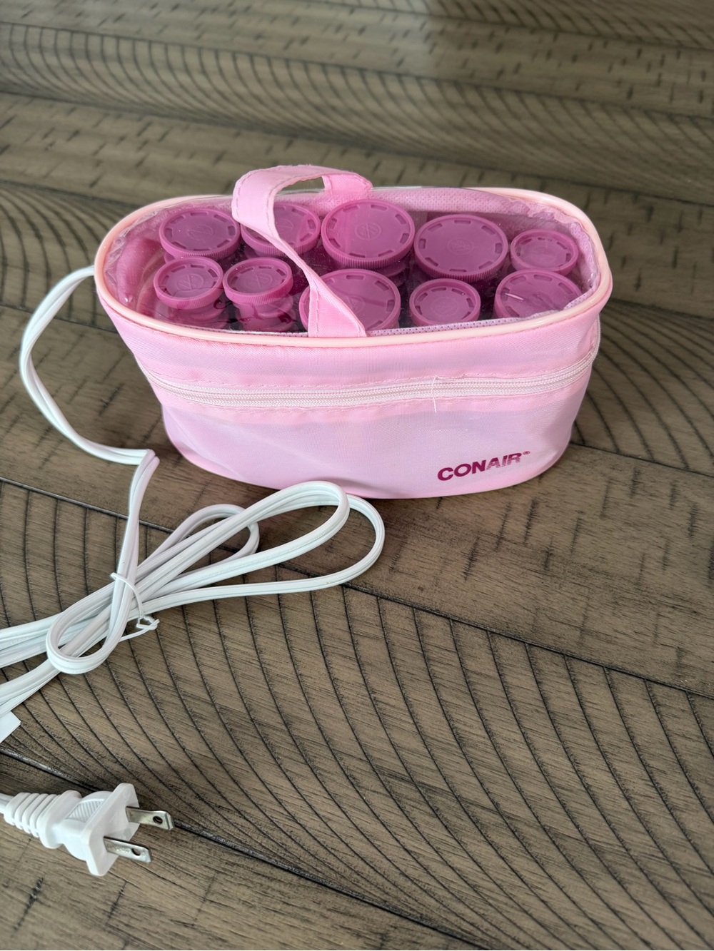 Conair Instant Heat compact hot roller set in a pink travel storage case.